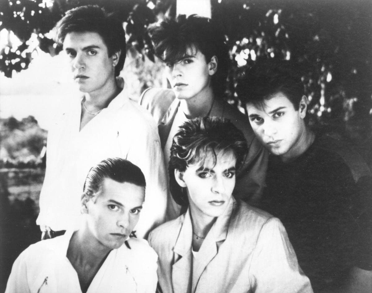 Duran Duran grouped close together in a 1983 publicity photograph