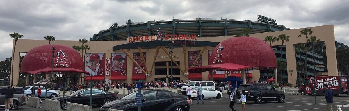 The exterior of Angel Stadium with giant red baseball caps at the entrance
