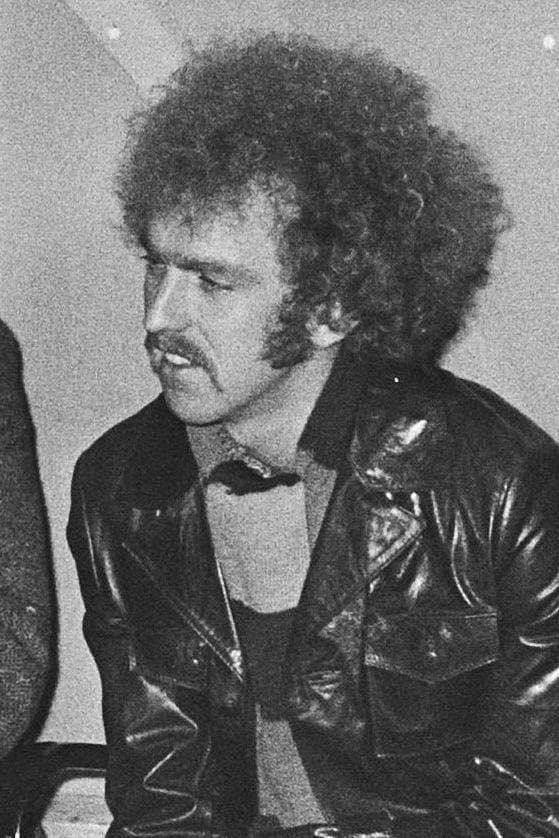 Black and white portrait of a young Bernie Leadon with shoulder-length hair