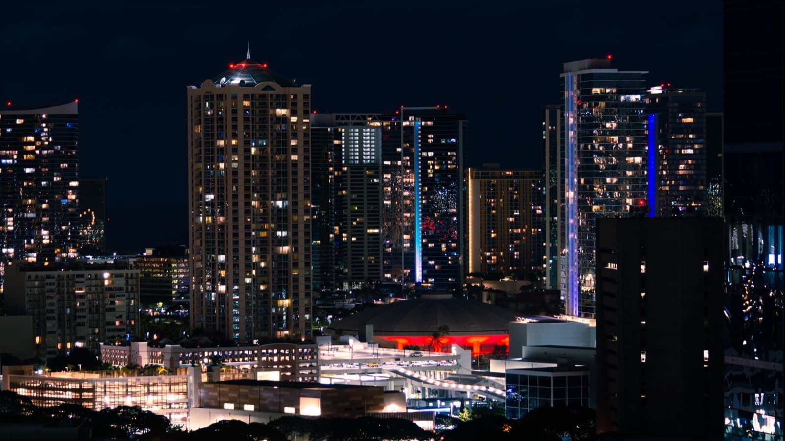 A round arena lit red at night
