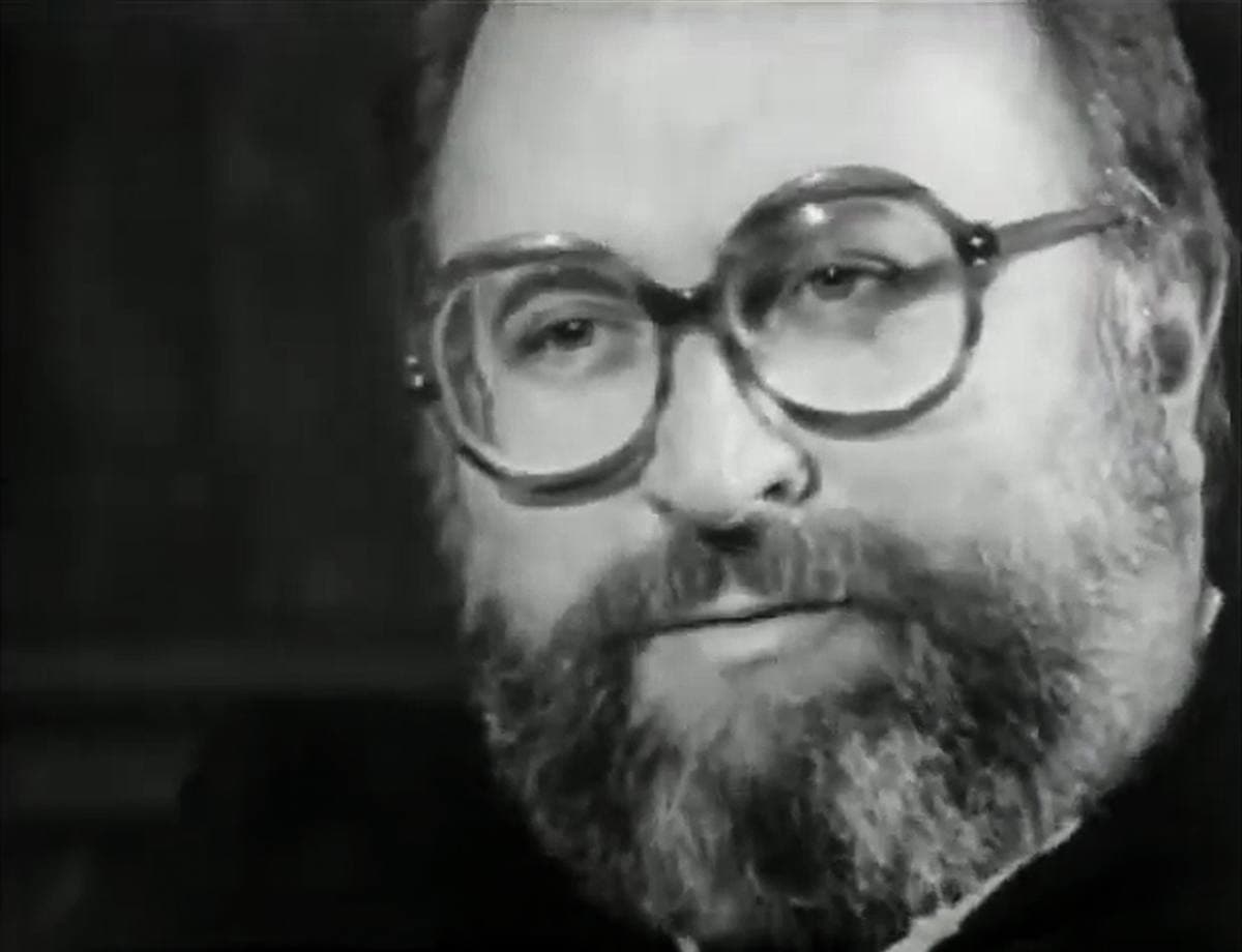 Sergio Leone, bearded and in glasses, speaking in a television interview