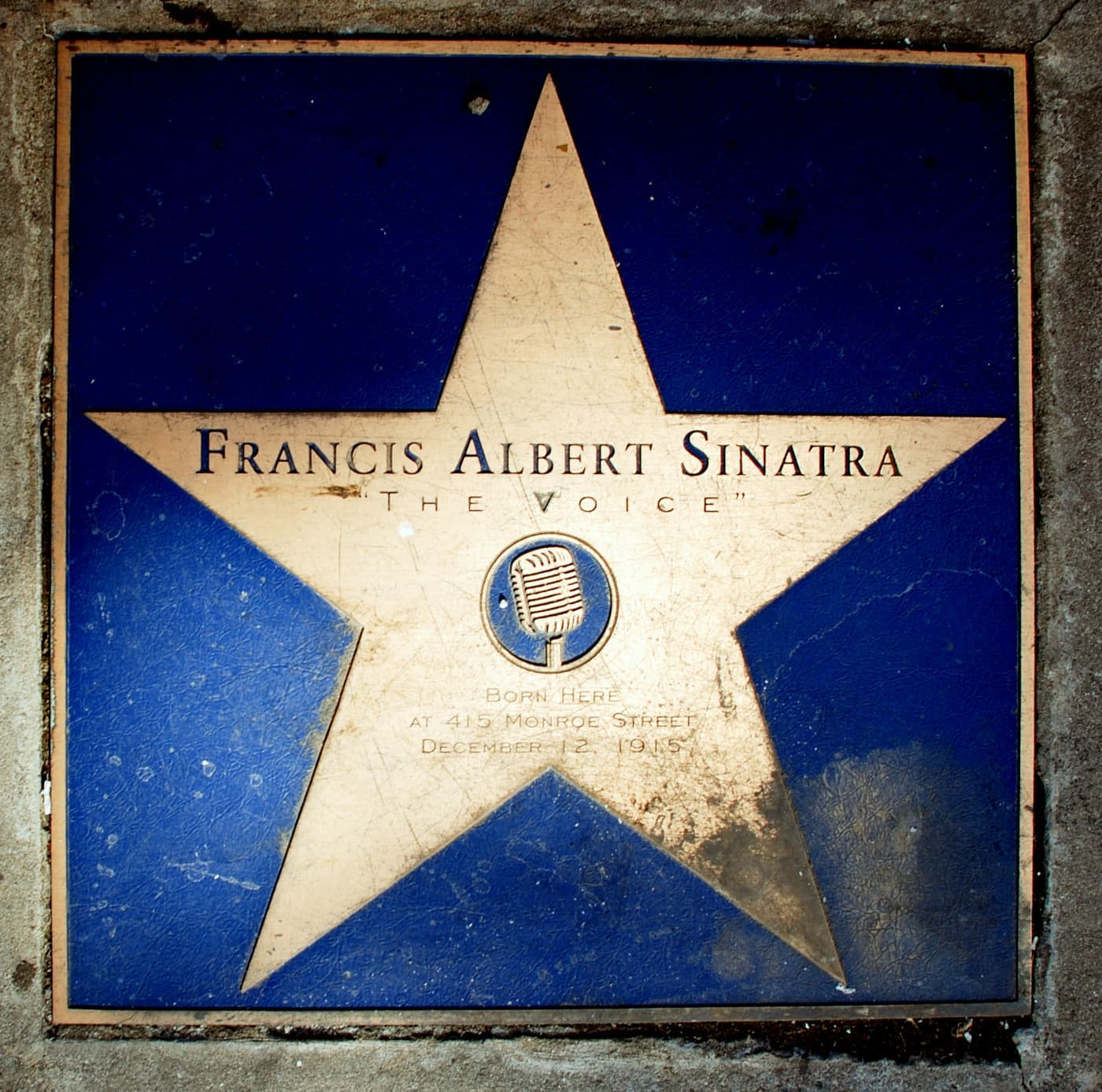 A bronze star set in the pavement marking Frank Sinatra’s birthplace