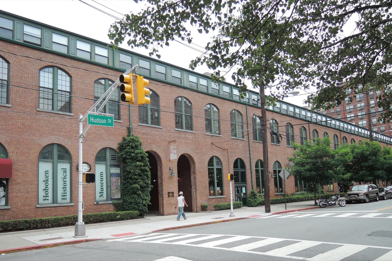A brick industrial building on a Hoboken street