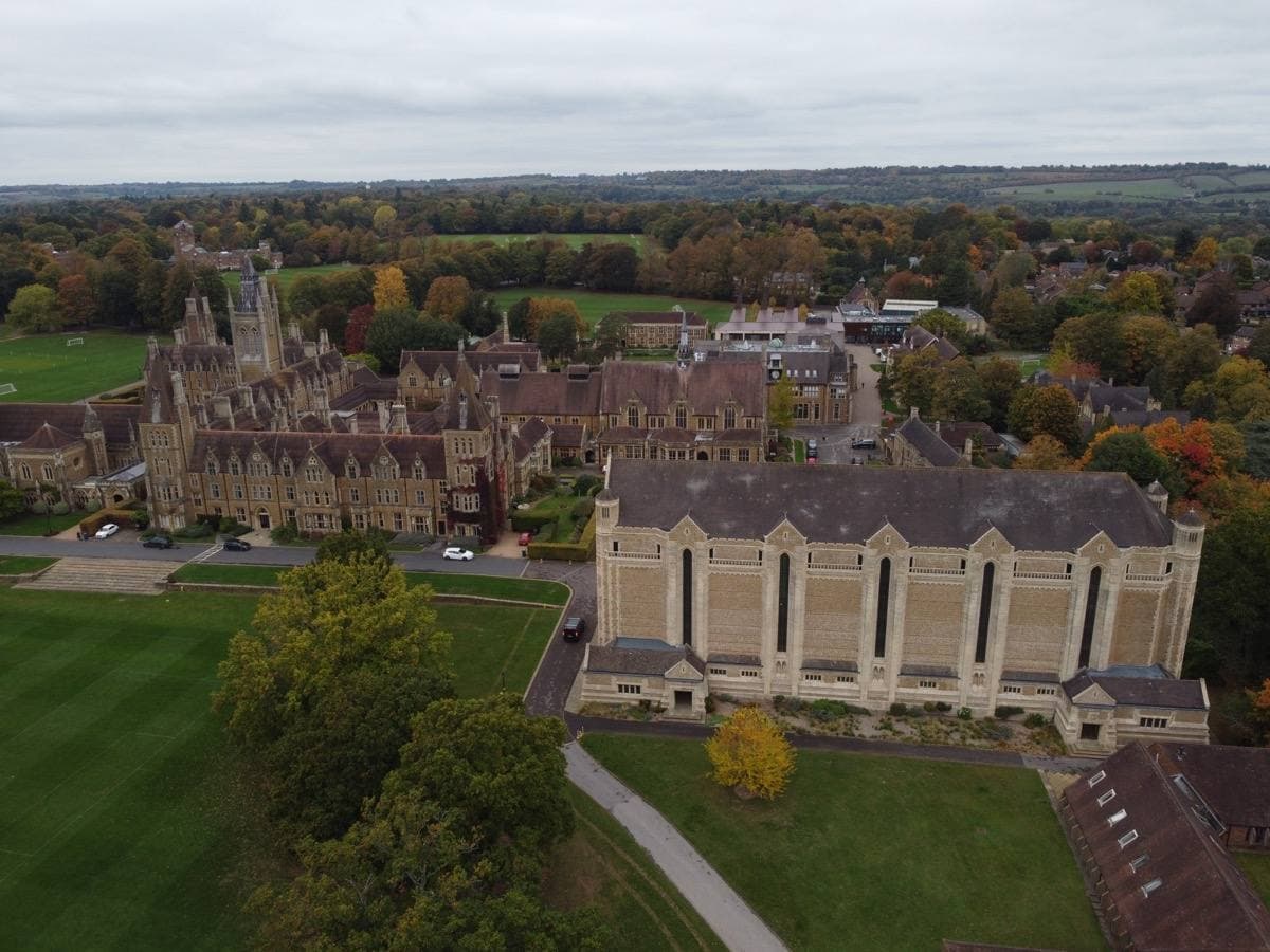 Stone school buildings and a lawn at Charterhouse