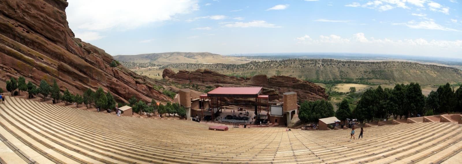 Panorama of tiered seats between two great red sandstone rocks, the plains beyond