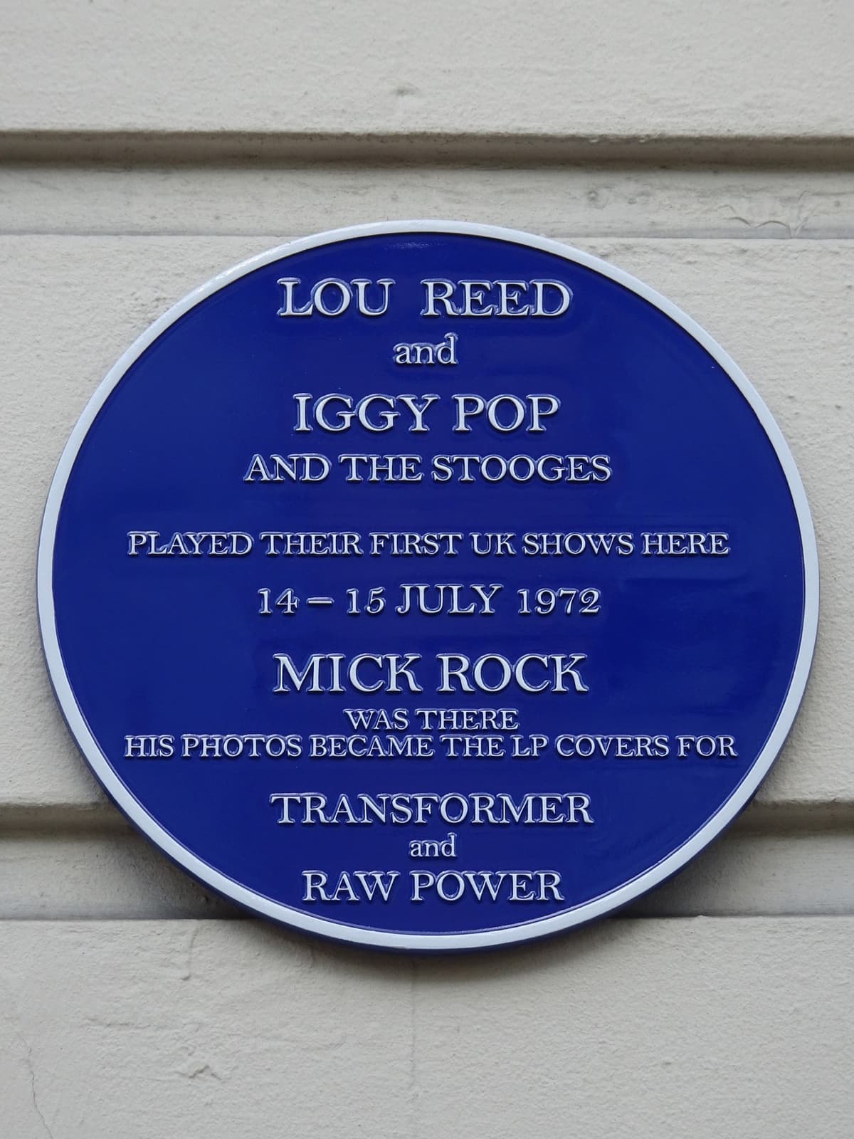 A round blue plaque naming Lou Reed, Iggy Pop and the Stooges and Mick Rock
