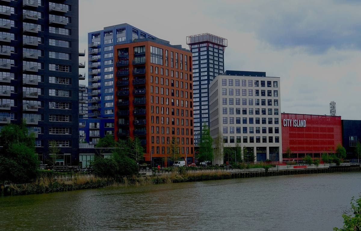 A tidal creek with new towers along the far bank