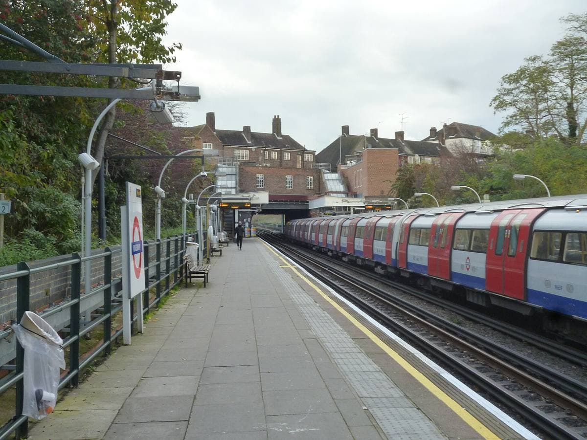 A suburban Underground platform with a train standing