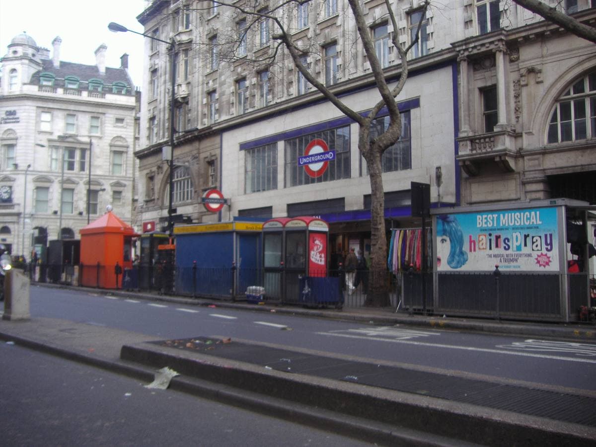 A wide London street of stone office blocks by an Underground entrance