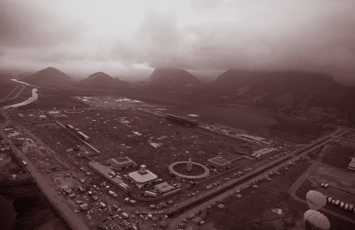An aerial view of a huge festival field and stage in sepia