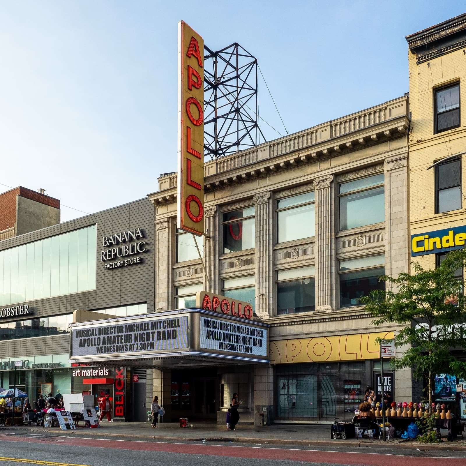 The Apollo Theater with its vertical sign and marquee on a sunny evening