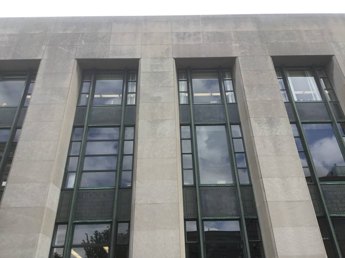 The tall curved limestone entrance of Brooklyn’s Central Library