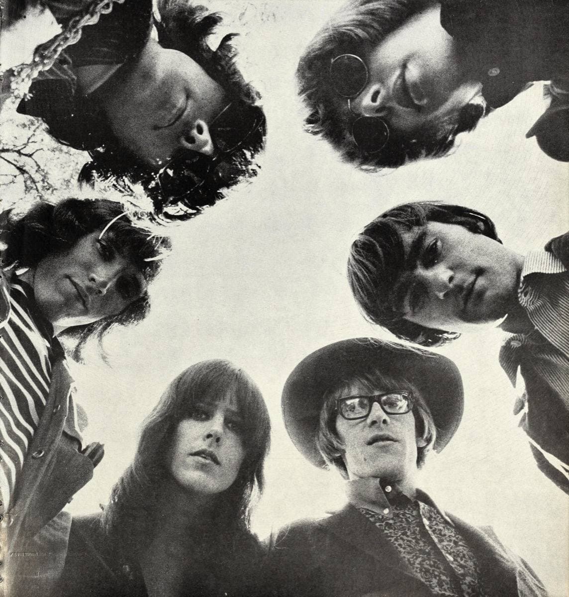 Six faces of Jefferson Airplane looking down into the camera in a ring