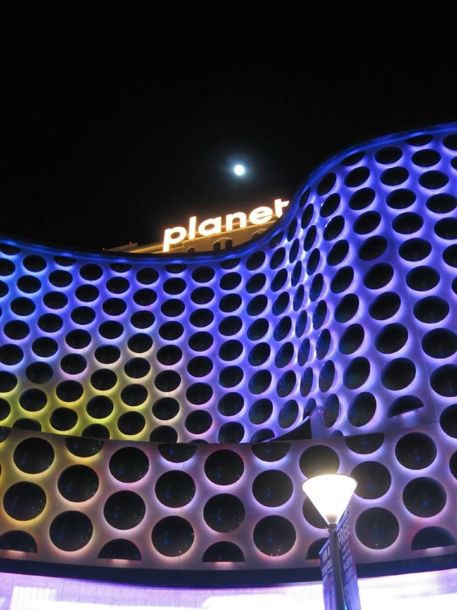 The lit tower of a casino resort on the Las Vegas Strip at night