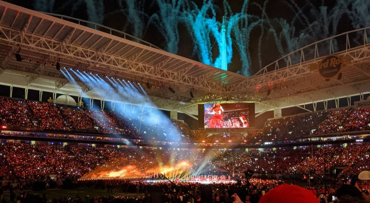 The halftime stage lit up in the middle of the stadium floor