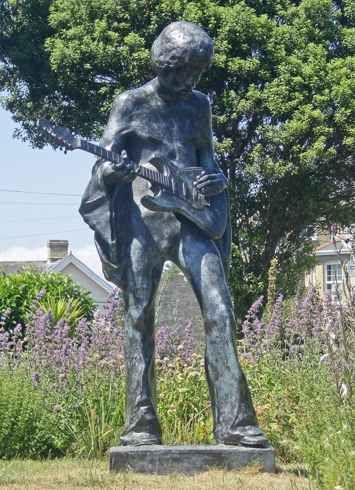 A bronze statue of Hendrix with a guitar among lavender
