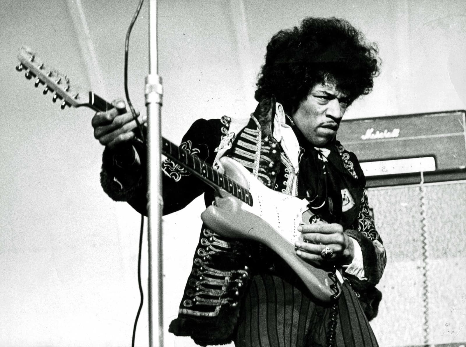 Jimi Hendrix plays a Stratocaster left-handed in front of a Marshall stack