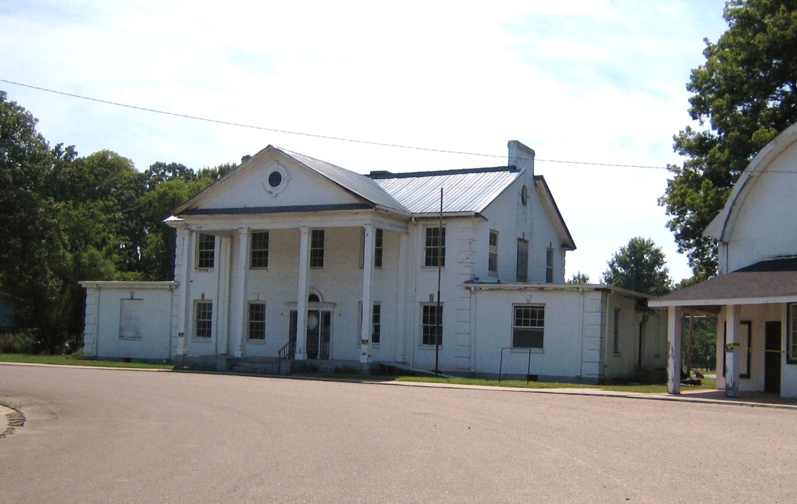 A low brick building with white columns