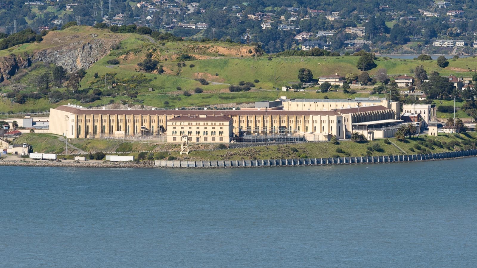 Pale prison buildings on the shore of San Francisco Bay