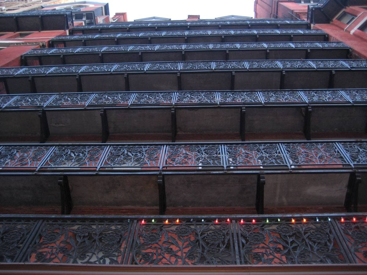 The red-brick Hotel Chelsea with its iron balconies and vertical neon sign