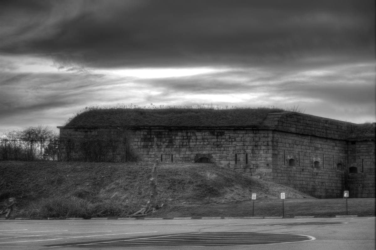 The granite walls of Fort Adams on a lawn by Narragansett Bay