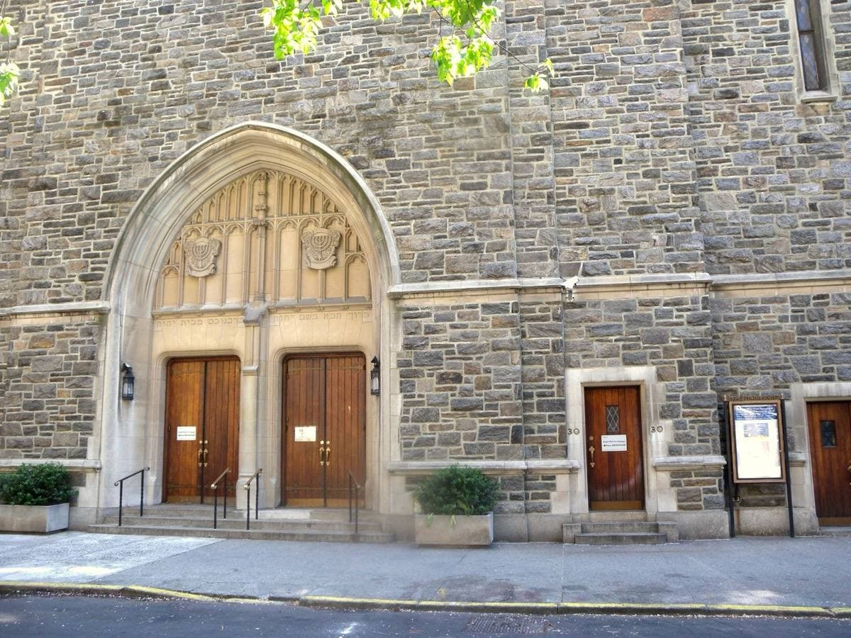 A stone synagogue on a sunny residential block of West 68th Street