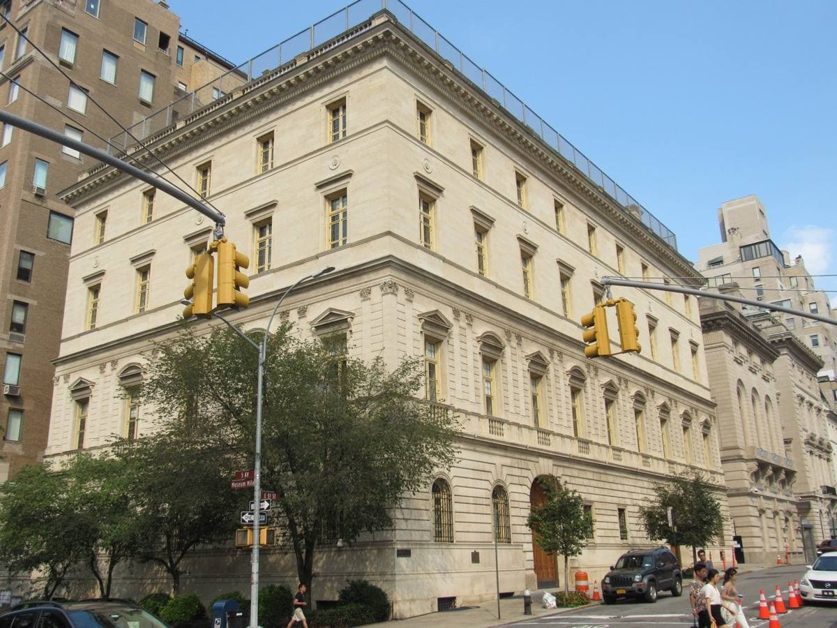 A pale stone Italian Renaissance-style mansion on a Manhattan street corner