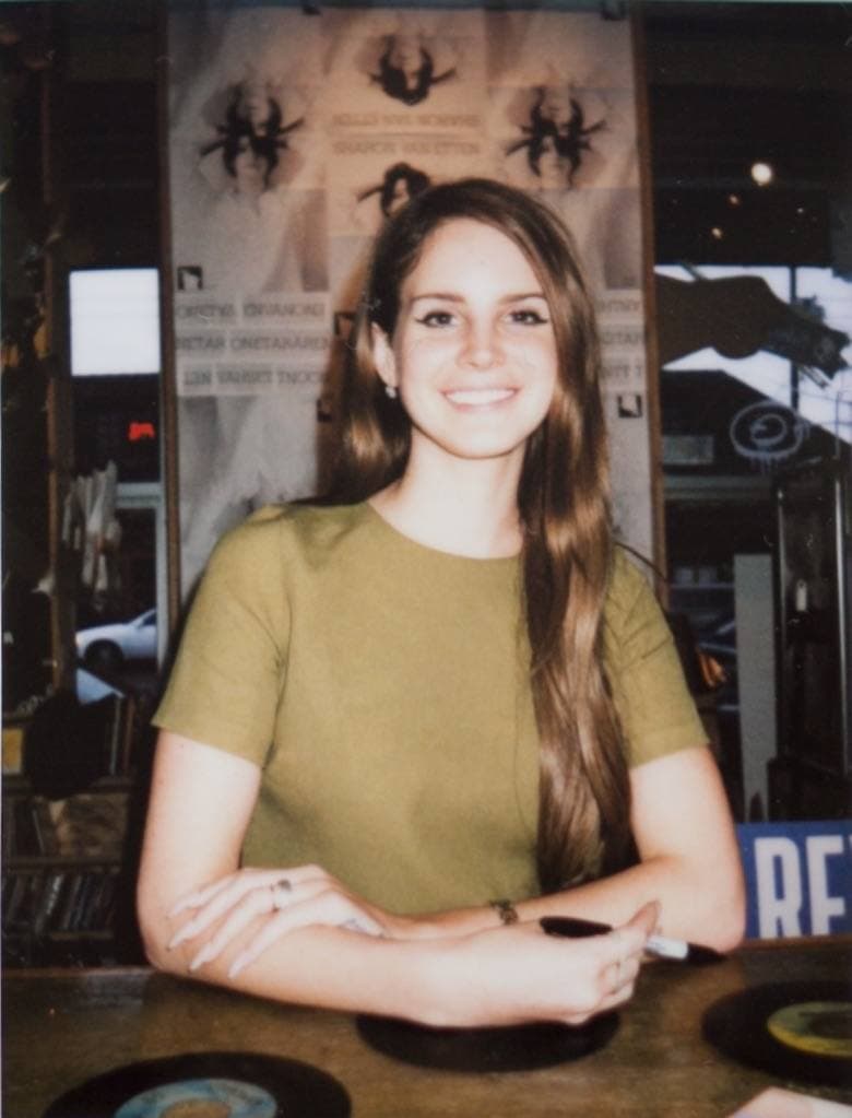Lana Del Rey smiling, her hair up