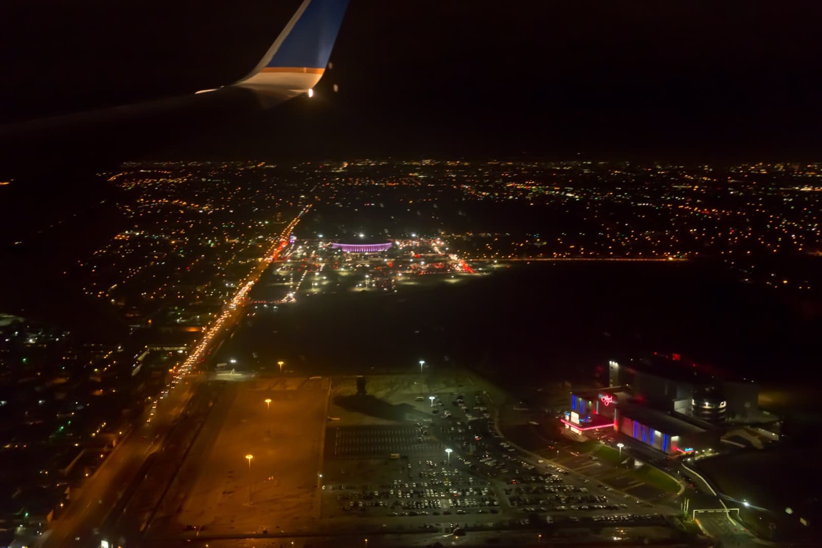The round Forum arena lit up at night, seen from above