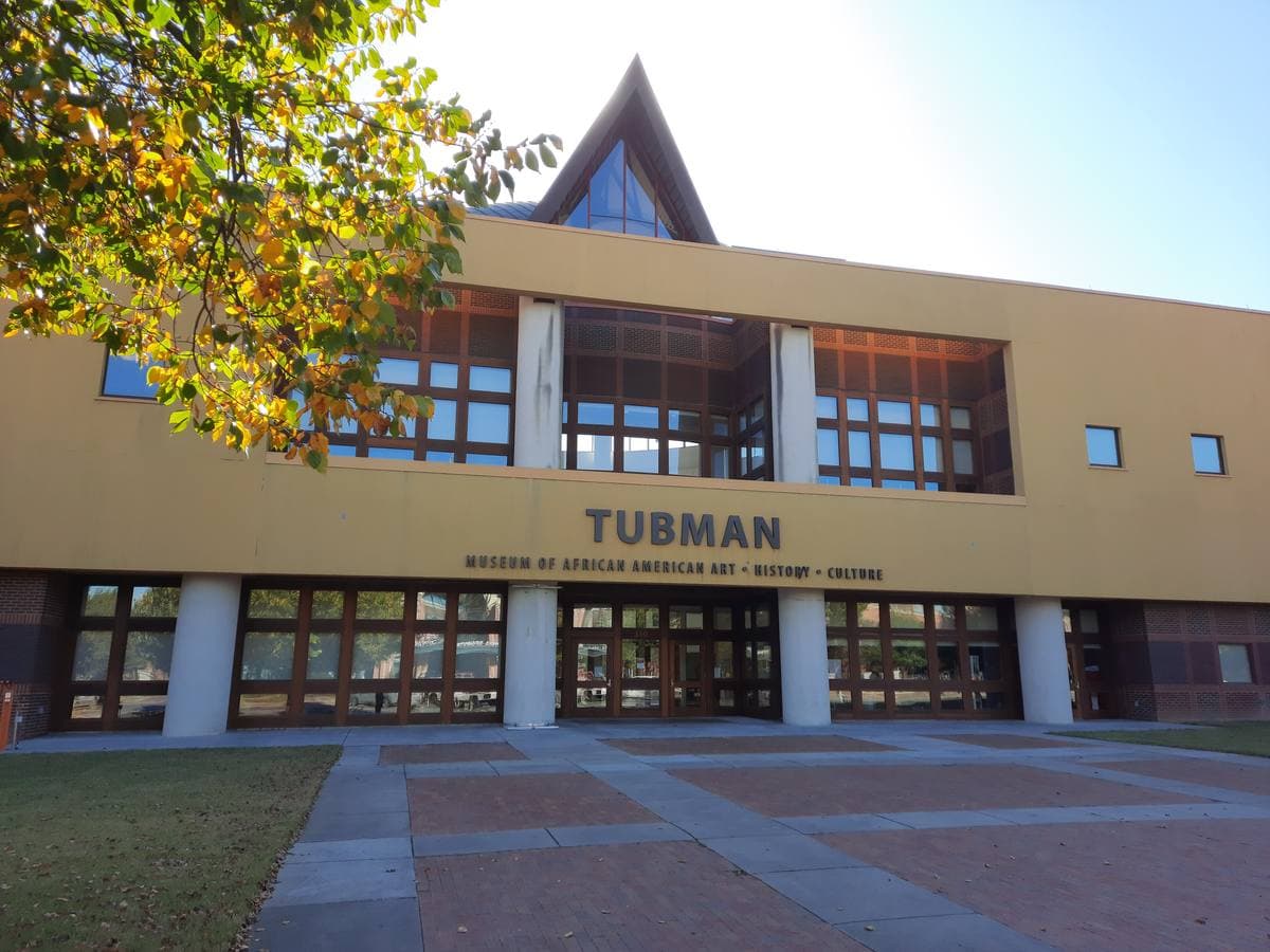 The entrance of a modern museum building with a tall pointed roof