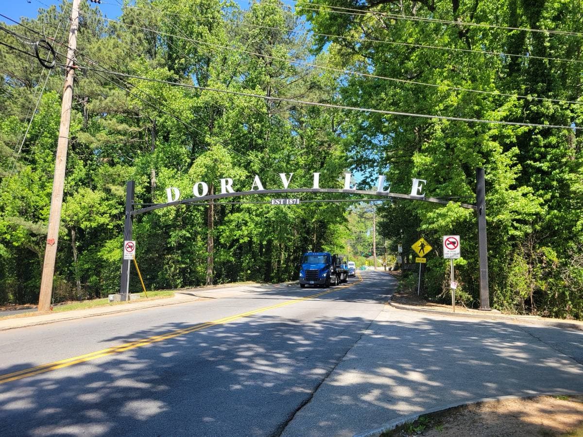 A Doraville town sign beside a road