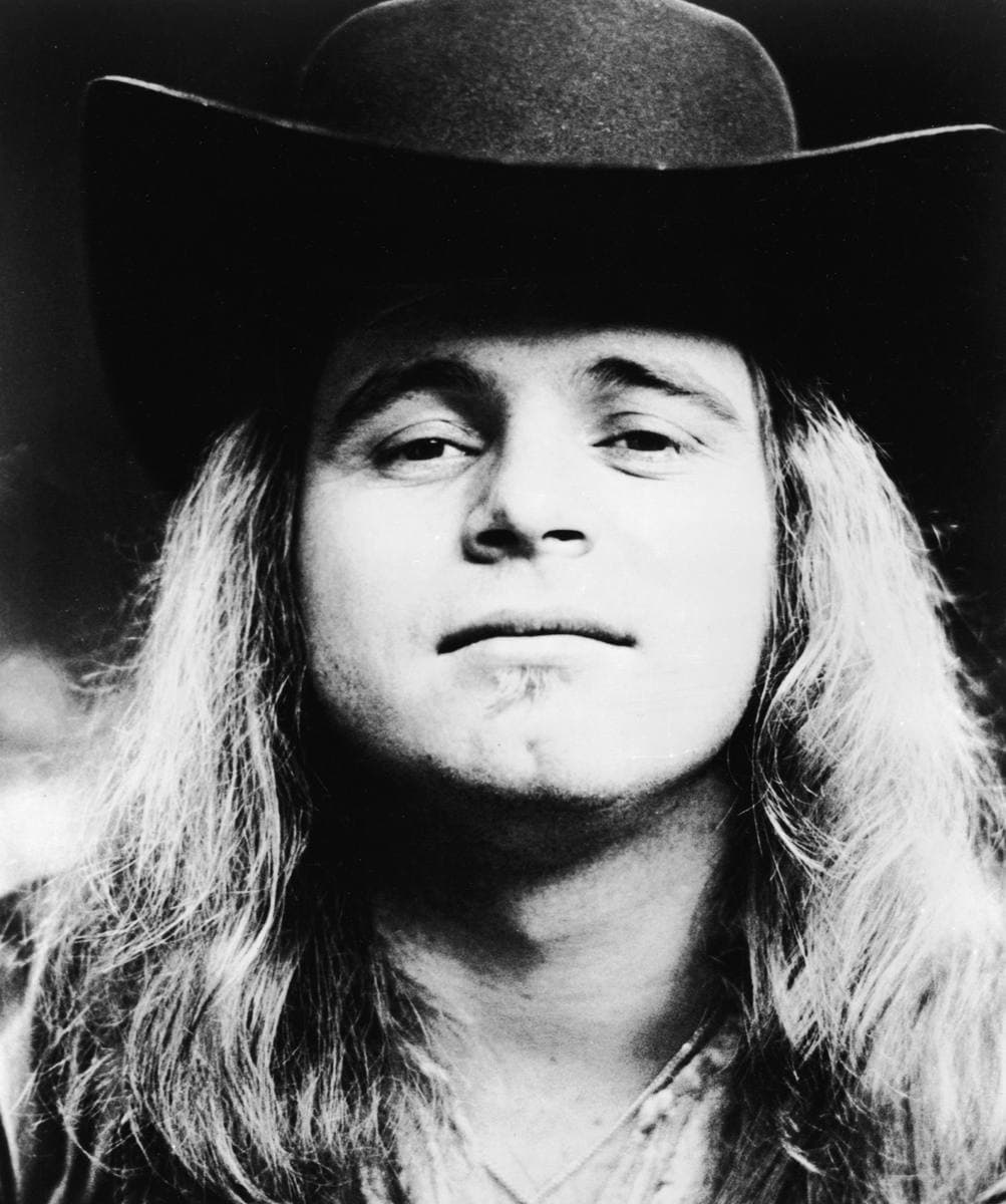 Ronnie Van Zant with long hair, looking at the camera