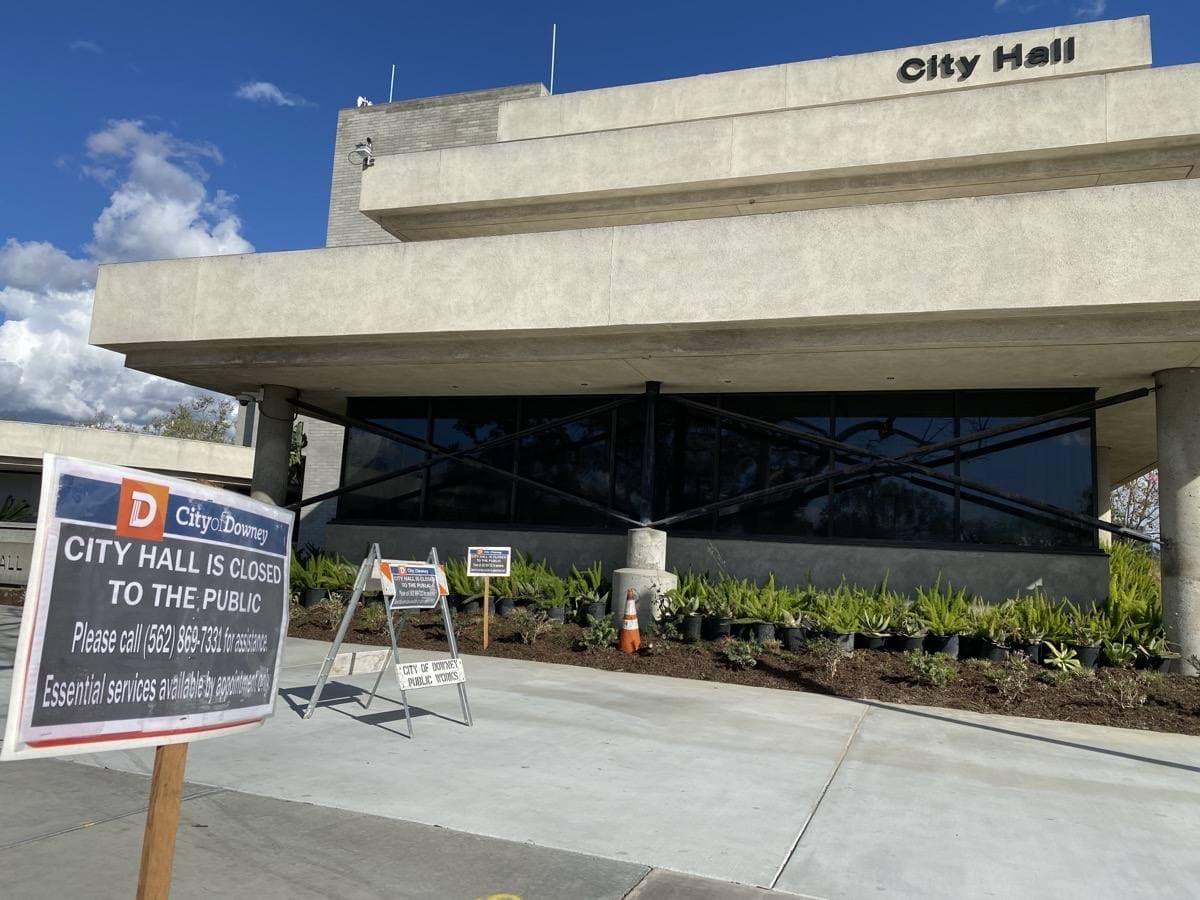 A low civic building with palm trees and an empty forecourt in Downey, California