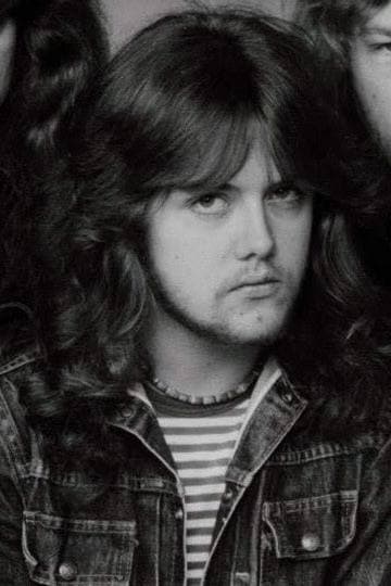 Lars Ulrich in 1983, long hair over a denim jacket and a striped T-shirt
