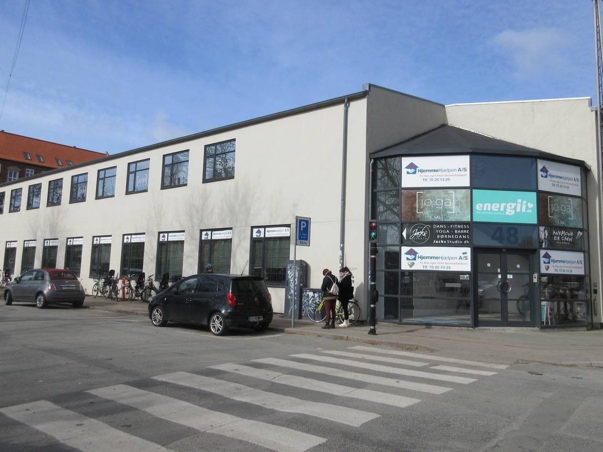 A Copenhagen street of low brick and concrete buildings on Amager