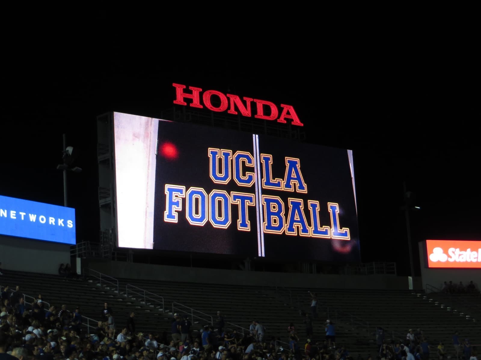 The Rose Bowl's oval of seats filling up under the evening sky
