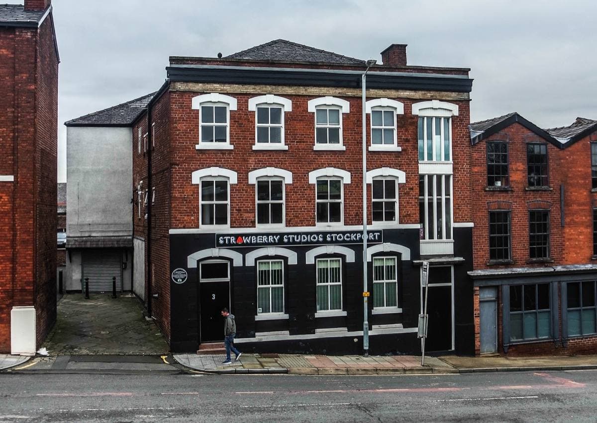 A red-brick corner building on a Stockport street