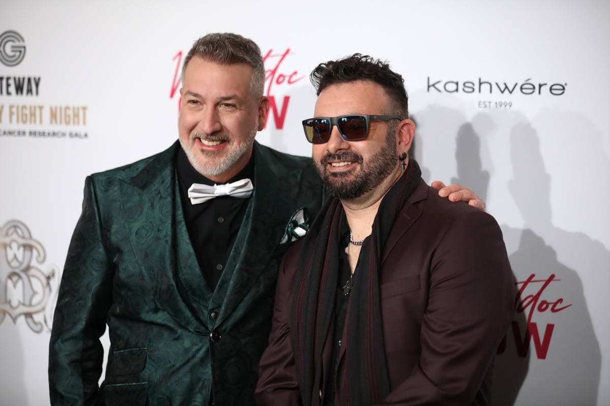Joey Fatone and Chris Kirkpatrick side by side on a red carpet