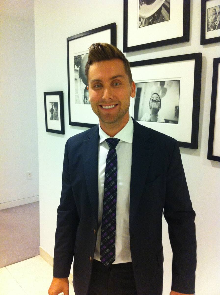 Lance Bass smiling at an evening event
