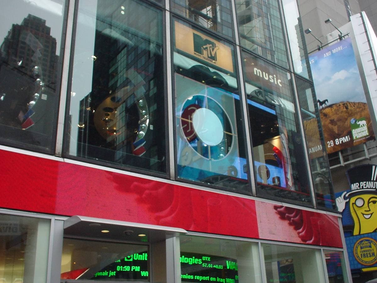Glass studio windows above the street in Times Square, with MTV signs, 2006