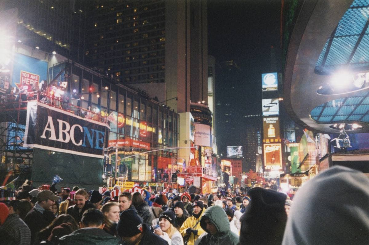 A packed crowd in Times Square at night under bright signs, 1 January 2000