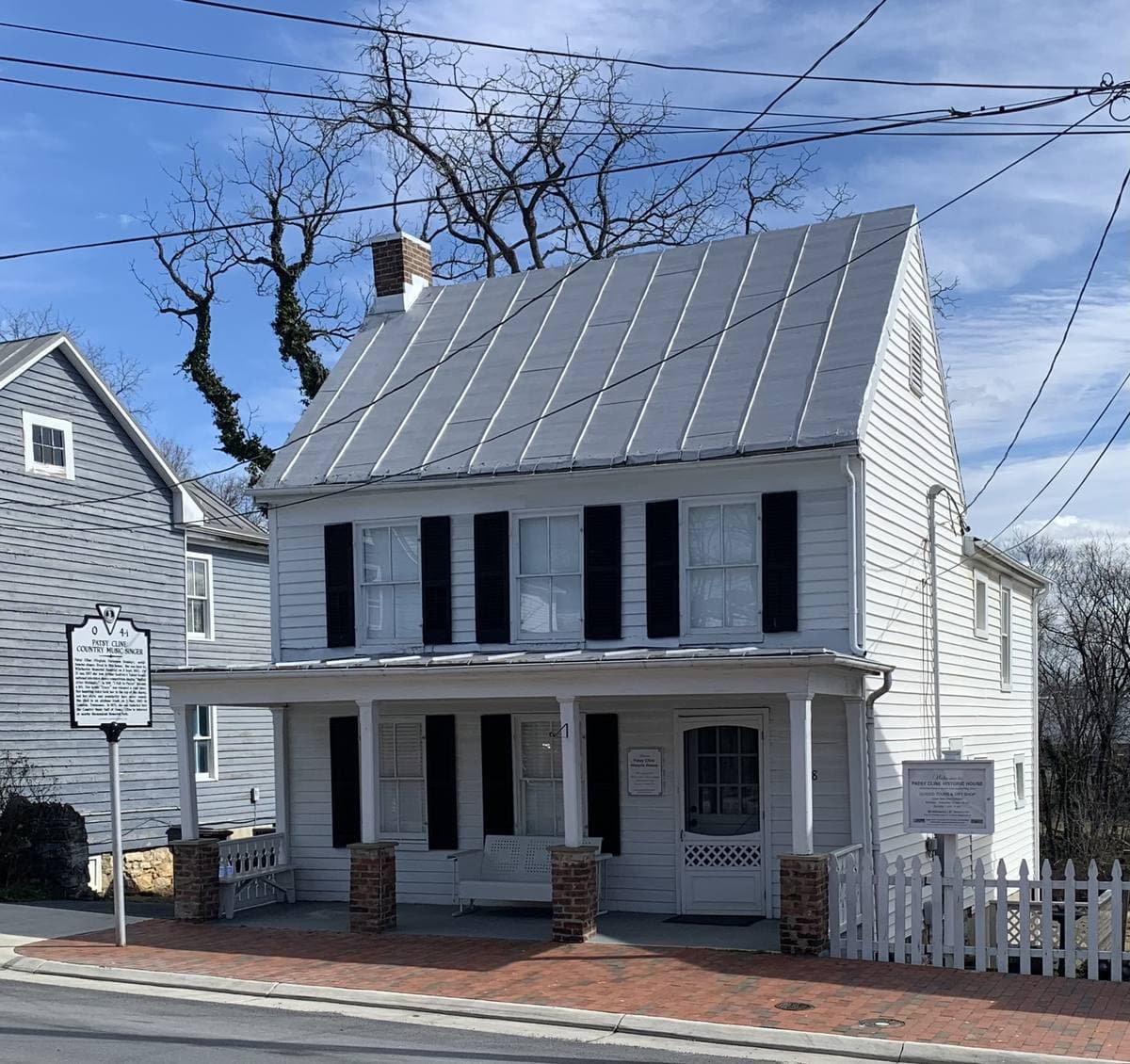 A row of clapboard houses along a Winchester street under a blue winter sky