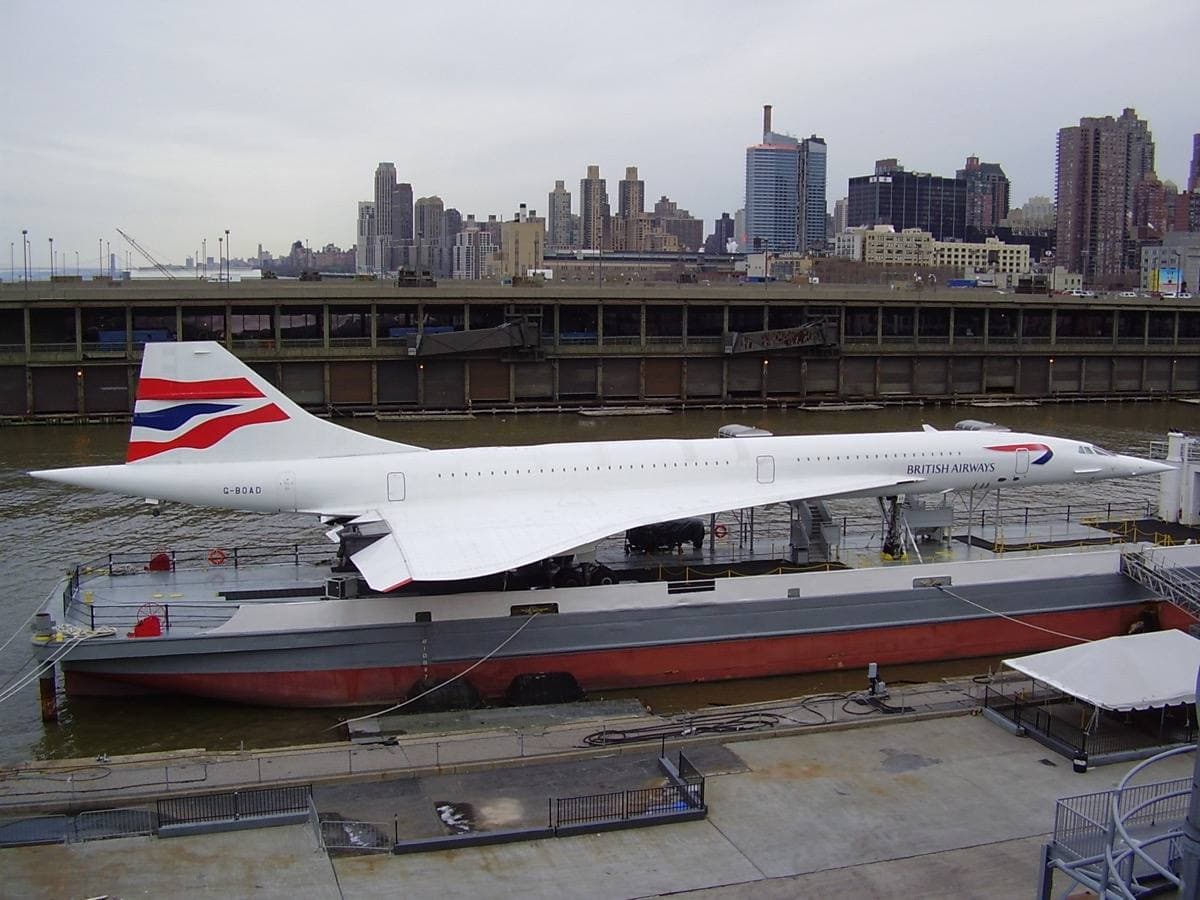 Concorde in British Airways colours on a pier beside the Hudson with Manhattan behind