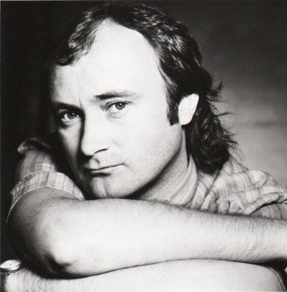 Black-and-white portrait of Phil Collins resting his chin on folded arms