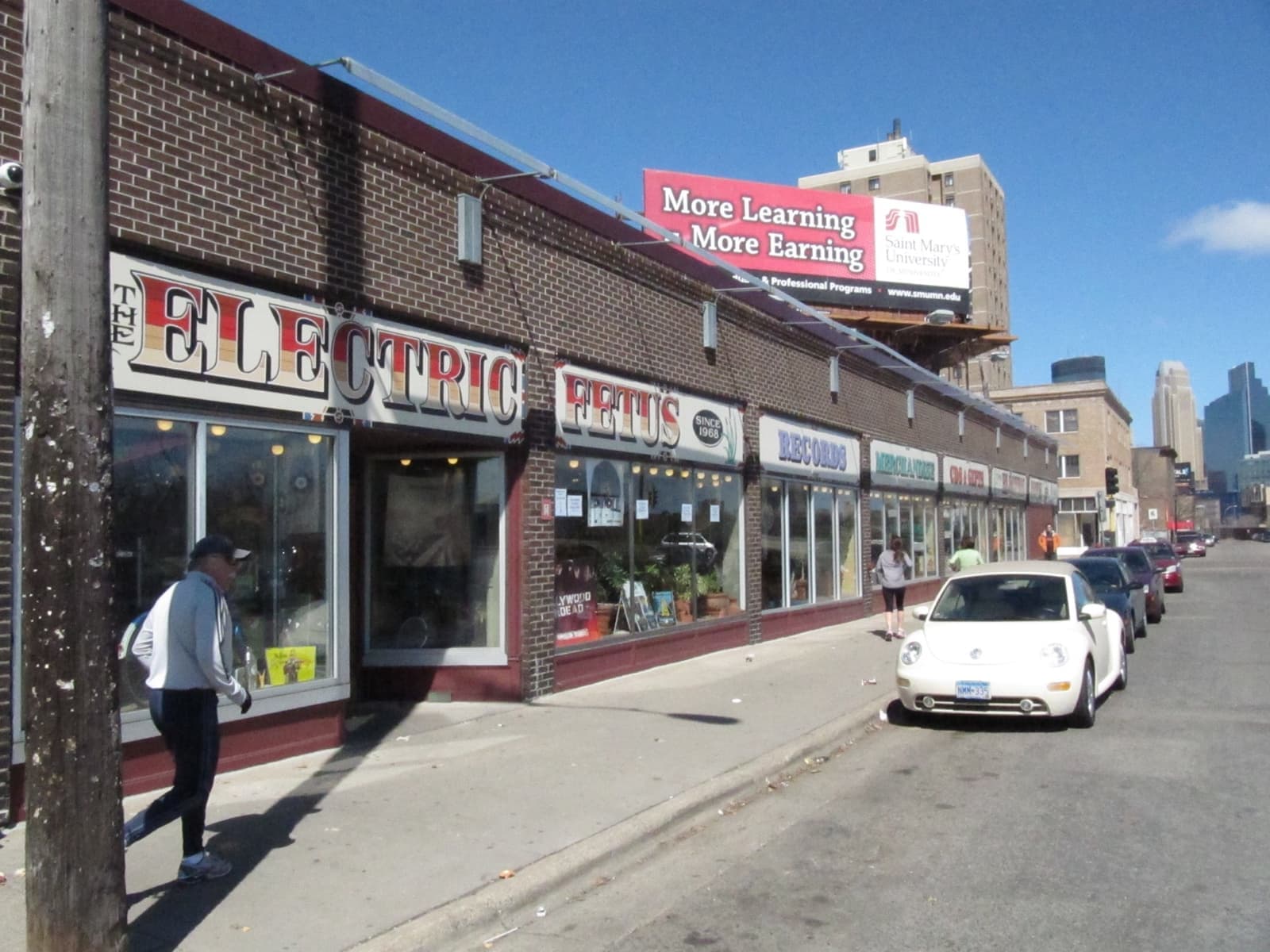 A long brick record shop with a painted sign and shop windows
