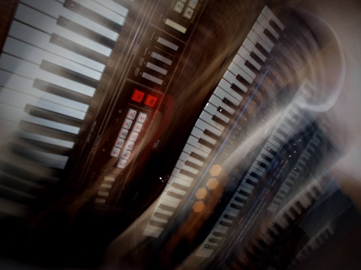 Four early-1980s Casio keyboards laid side by side at an angle, the black Casiotone MT-500 second from the left with red buttons by its keys