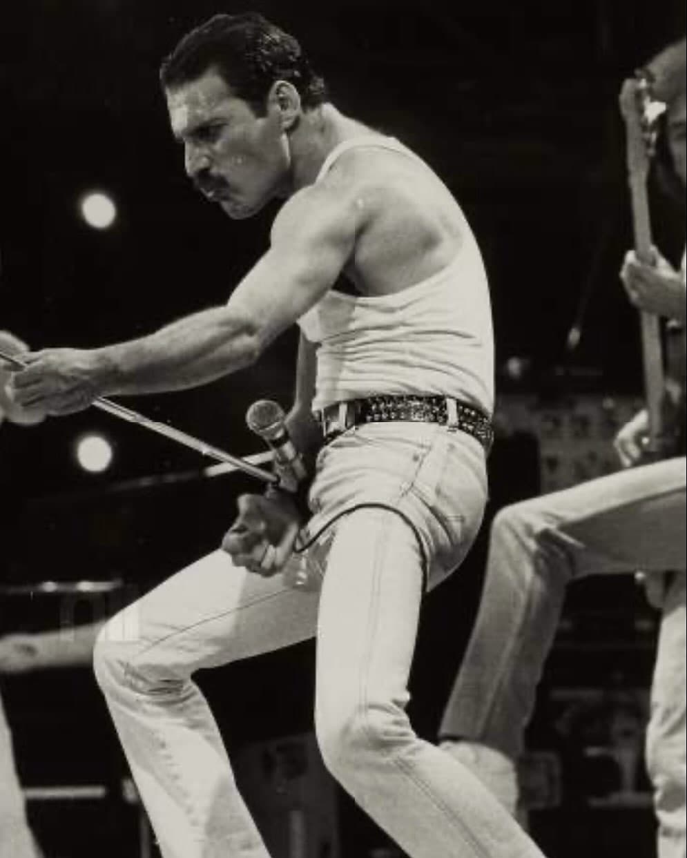 Freddie Mercury singing at Live Aid in a white vest