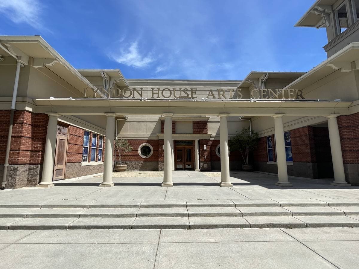 A broad entrance canopy on pale columns with the words Lyndon House Arts Center