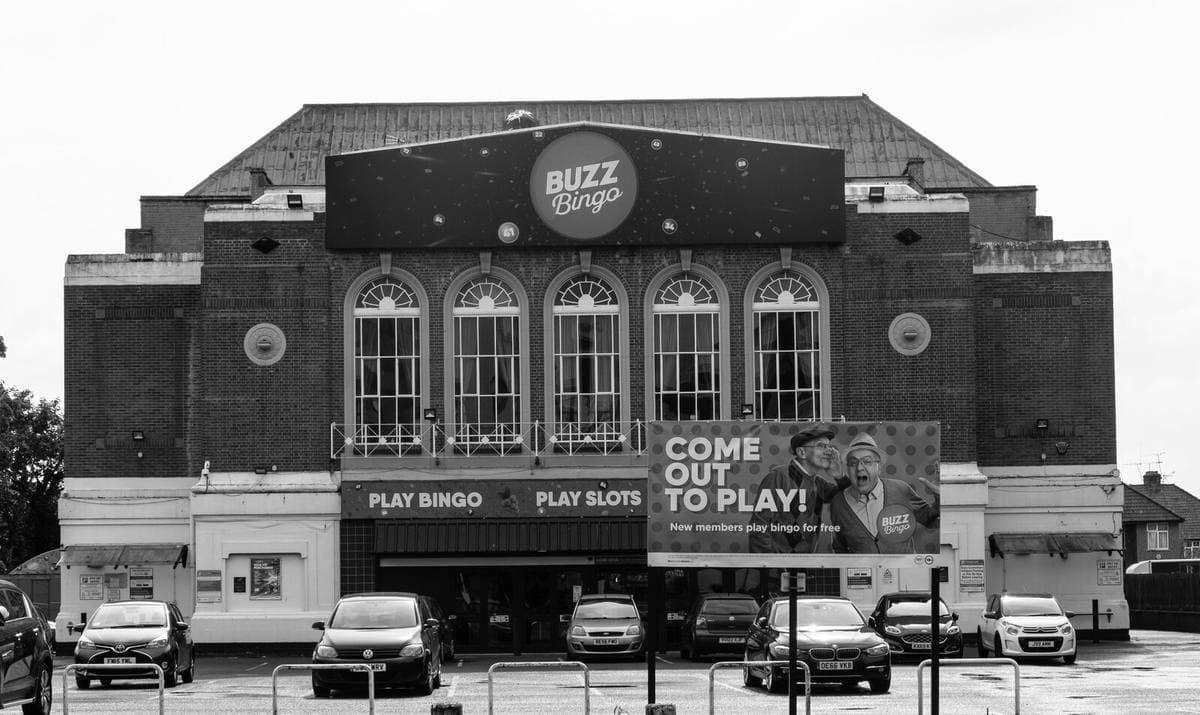 A brick cinema building with arched windows and a bingo sign