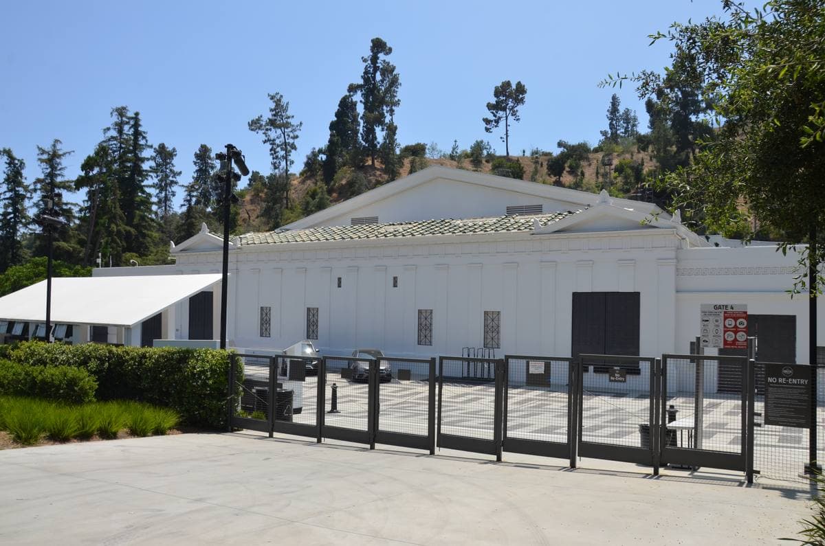 The white stage house of an open-air theatre among pines